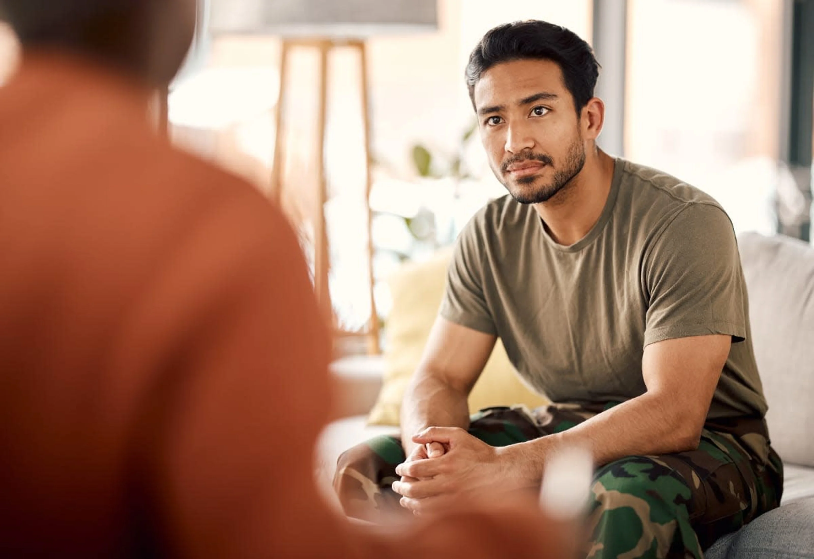 A diverse group of people gathered in a supportive community setting in Hawaii